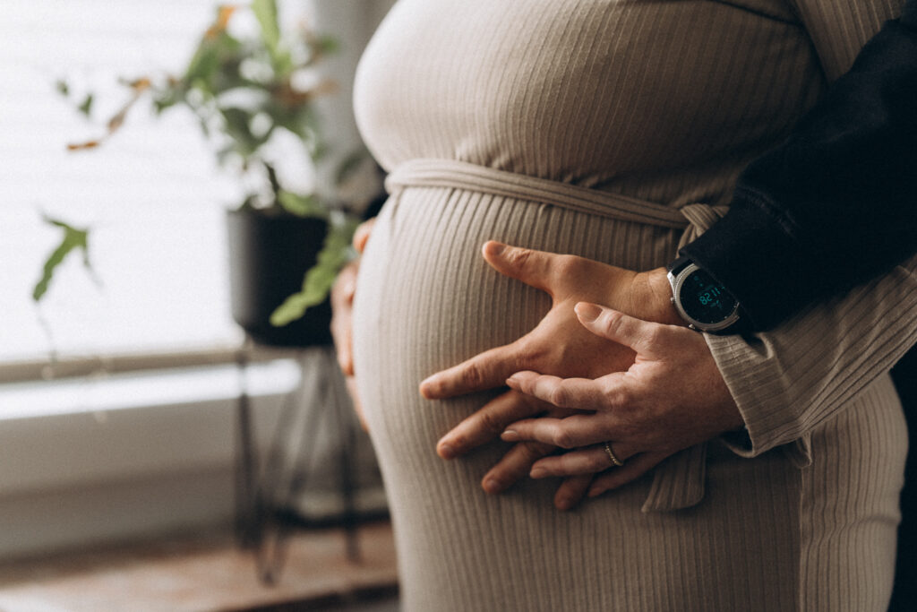 Babybauchshooting Mama und Papa legen Hand auf den Bauch